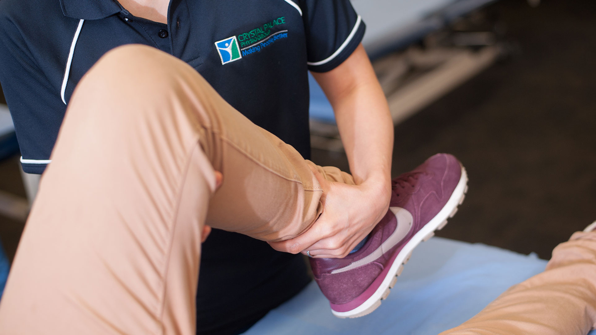 Image Physio checking knee joint flexibility