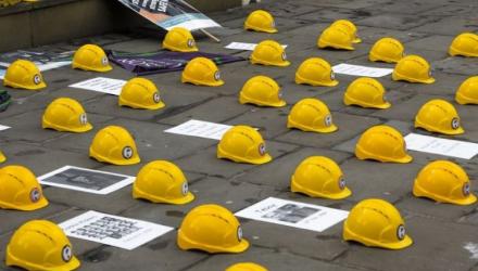 safety helmets laid on the floor in tribute to workers who have died