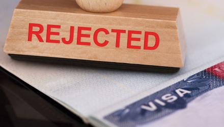 A large rejected stamp on a visa application