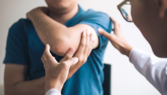 Man holding painful elbow