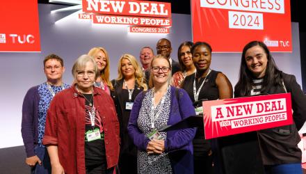 The CSP's delegation and non-voting guests at the TUC's podium.  (R) Jess Hurd.