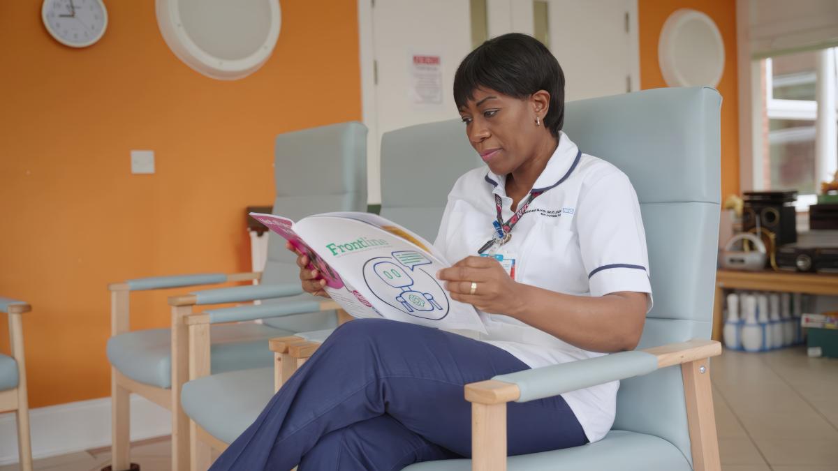 A physiotherapist reading Frontline sitting down